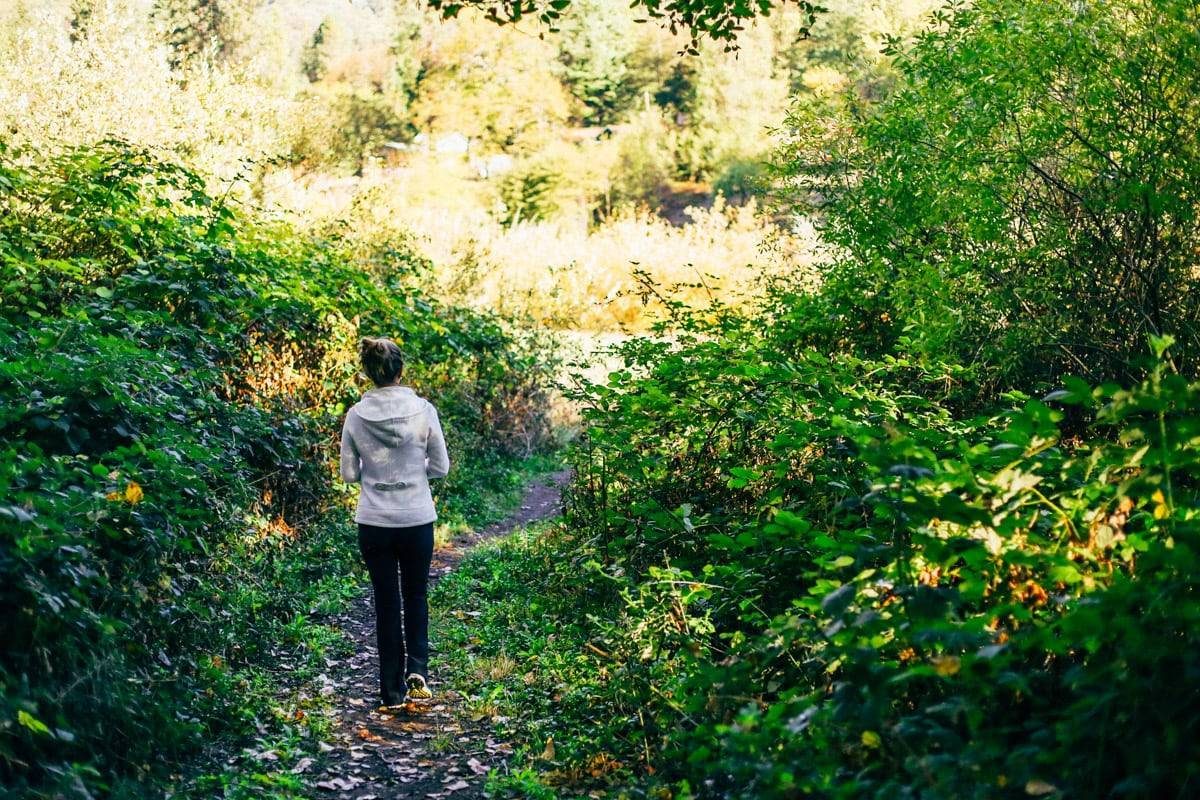 Woman walking in the woods.