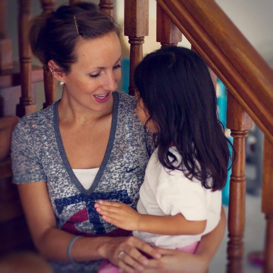 Woman holding a young girl.