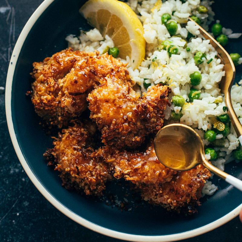 Coconut shrimp in a bowl with rice and peas