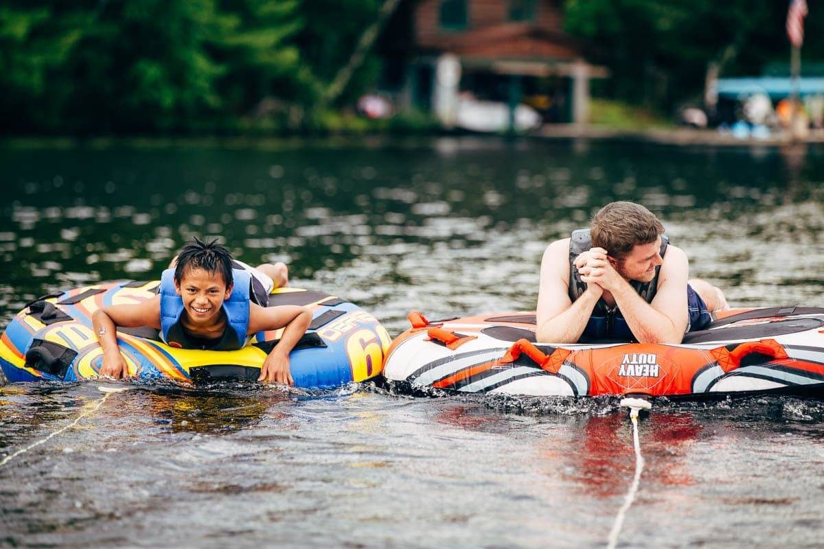 boys on inner tubes in a lake