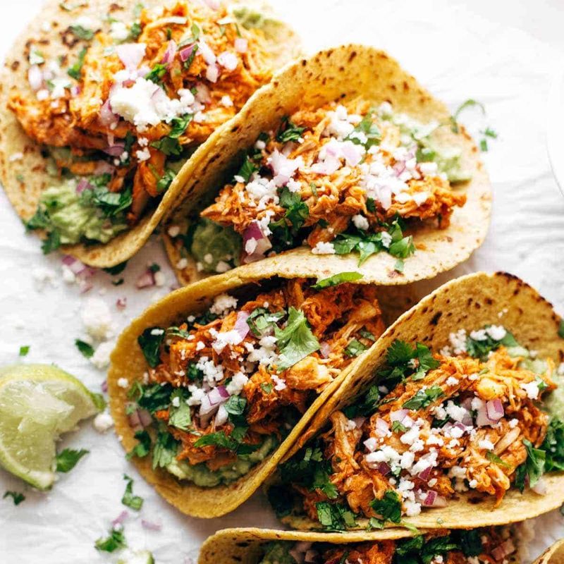 Chicken Tinga Tacos in a row.