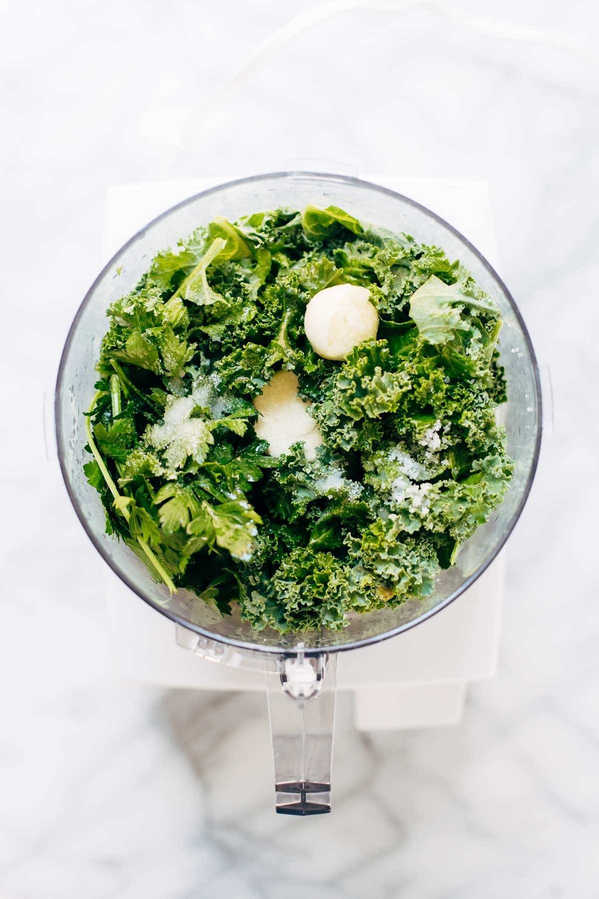 5 Minute Vegan Kale Pesto - made with almonds, olive oil, kale, garlic, salt, and lemon juice. Less than 150 calories per serving! | pinchofyum.com