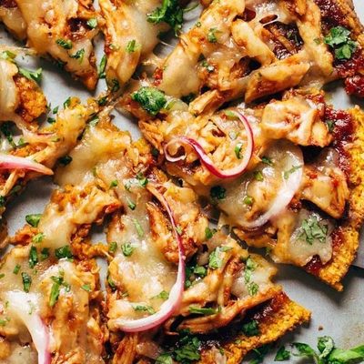 Sweet Potato Pizza on pizza pan with spatula.