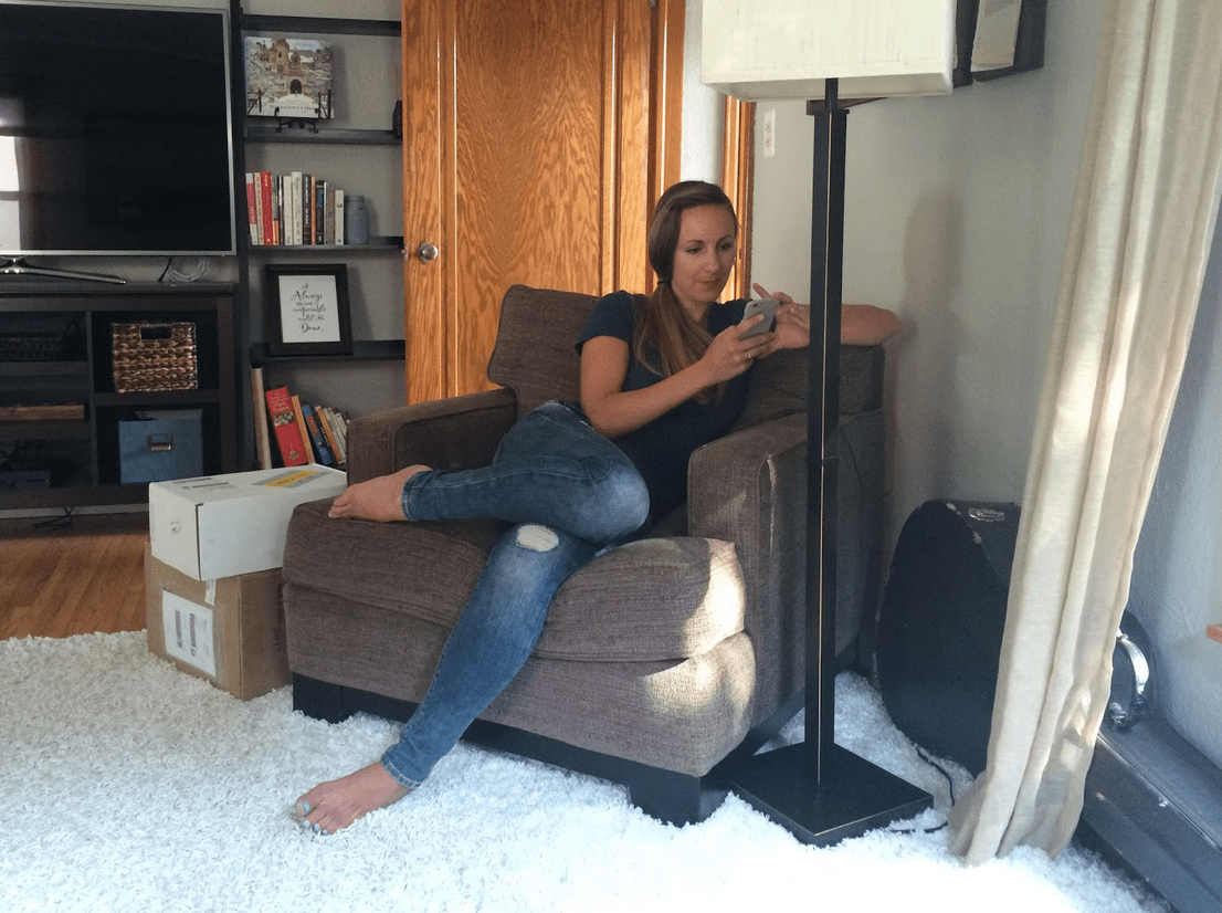 Woman sitting on her phone in a chair.