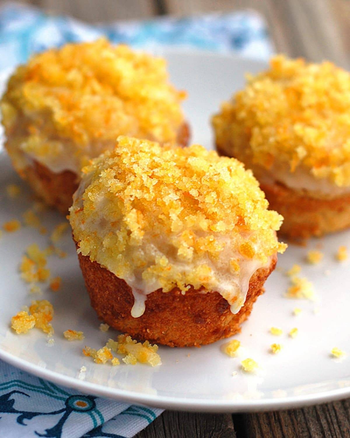 Whole wheat glazed orange muffins topped with a sugary zest. 